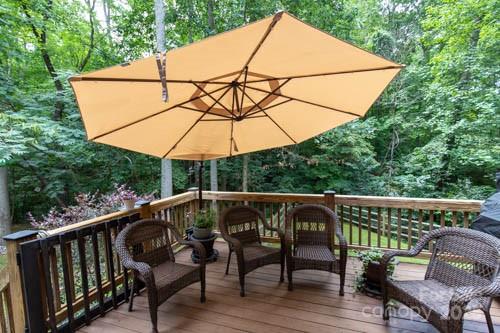 207 Streamside Place Mooresville, NC 28115 - Photo 35 of 42 a roof deck with table and chairs under an umbrella