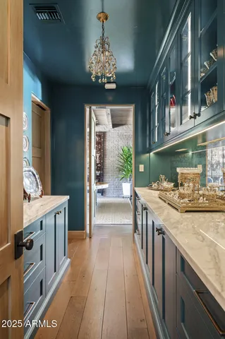 a view of a patio with table and chairs potted plants and palm trees