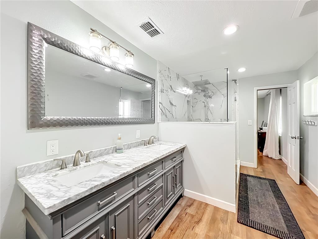 153 Variety Tree Circle Altamonte Springs, FL 32714 - Photo 24 of 44 a bathroom with a sink a vanity and a mirror