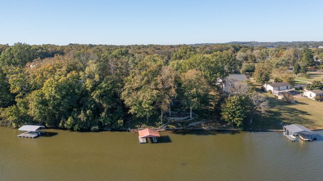 a view of a lake with houses in the back