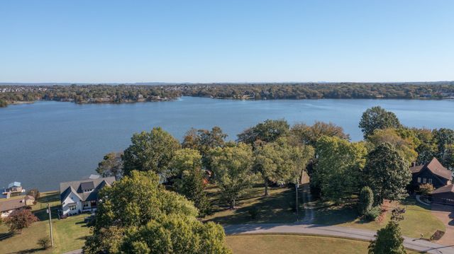 a view of a patio with a table chairs and a fire pit
