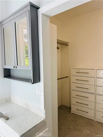 a view of walk in closet with cabinet