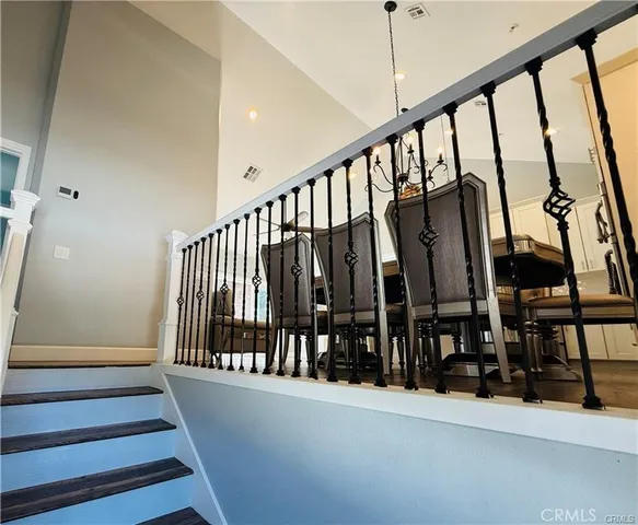 a view of staircase with lots of frames on wall and a window