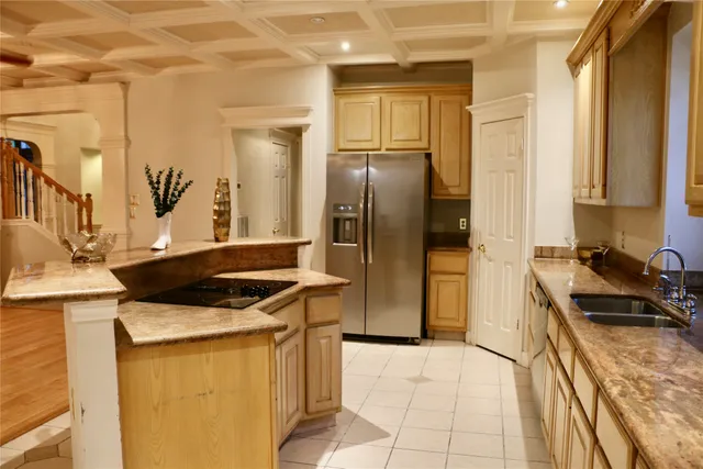 a kitchen with a stove a refrigerator and a sink