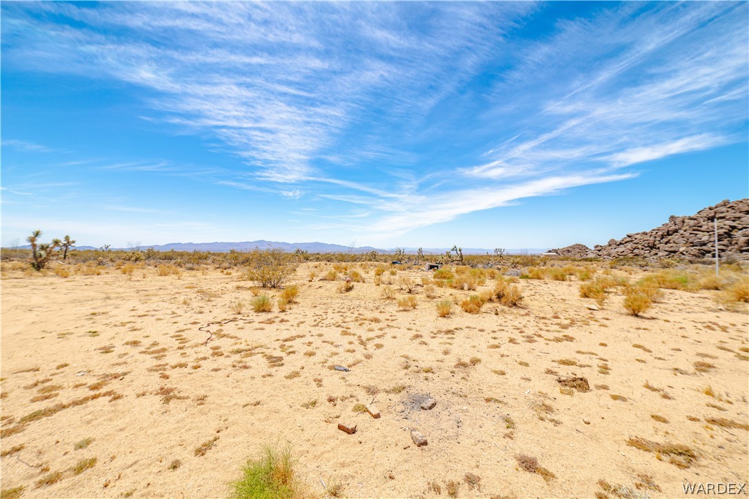 16435 South Wyatt Earp Road Yucca, AZ 86438 - Photo 36 of 57 Expansive desert landscape featuring low-lying vegetation and distant mountains