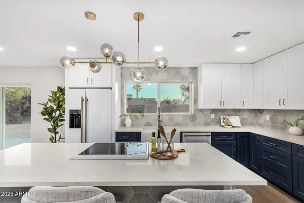 a kitchen with a stove a refrigerator and a sink