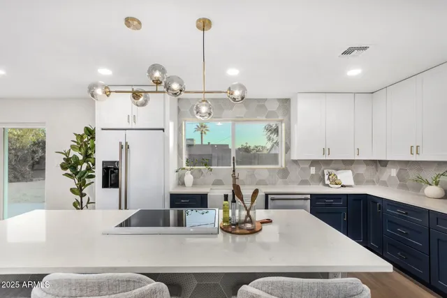 a kitchen with a stove a refrigerator and a sink