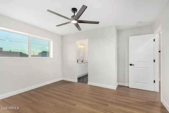 a view of a big room with wooden floor and windows in a room