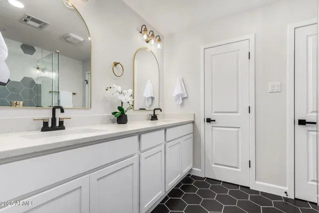 a spacious bathroom with a double vanity sink mirror and