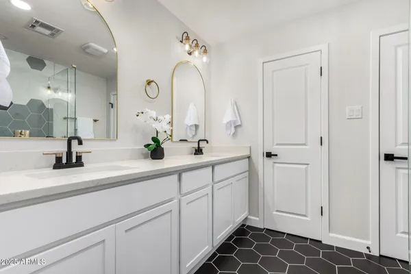 a spacious bathroom with a double vanity sink mirror and