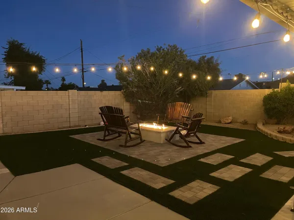 a view of a patio with a dining table and chairs