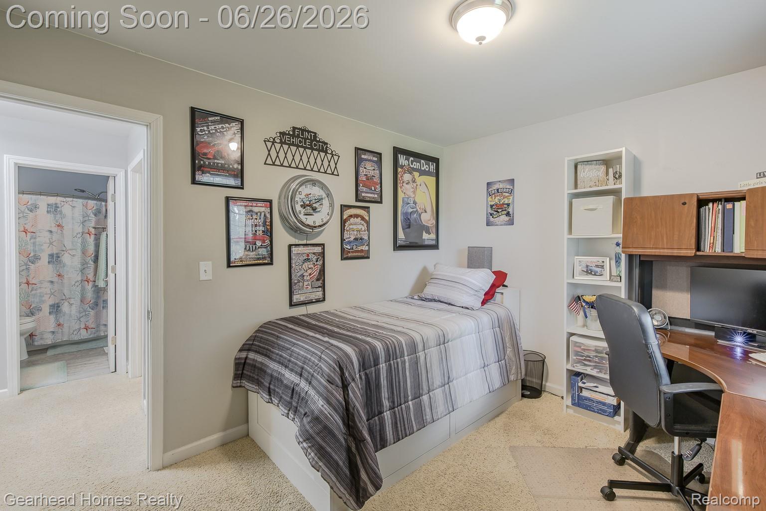 12364 Morrish Road Clio, MI 48420 - Photo 35 of 81 Carpeted bedroom with a built-in wood-finish desk featuring an upper cabinet, a white freestanding bookshelf, and a ceiling-mounted light fixture