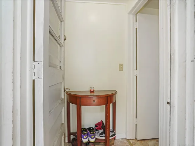 a bathroom with a granite countertop toilet sink and mirror