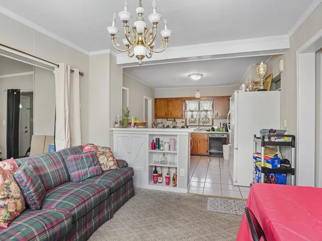 a living room with furniture and a chandelier