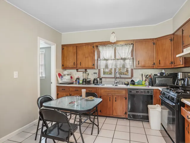 a kitchen with granite countertop a sink stove and cabinets