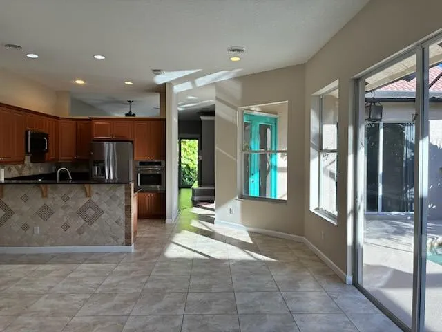 a kitchen with stainless steel appliances granite countertop a refrigerator and a stove