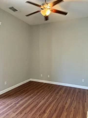 a view of a room with wooden floor