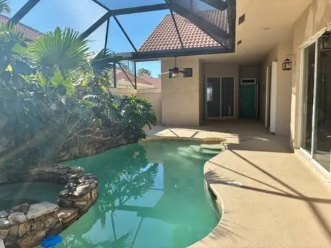 a swimming pool with barbeque oven in front of it