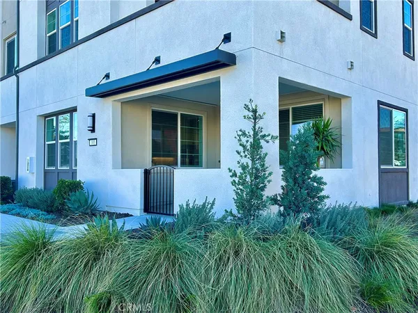 front view of a house with potted plants