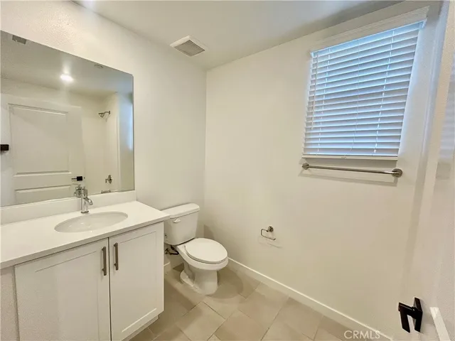 a bathroom with a sink a toilet and vanity