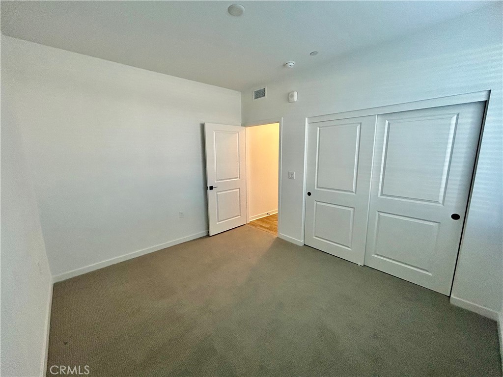 6114 Valentina Way, Unit 101 Eastvale, CA 92880 - Photo 18 of 23 an empty room with windows
