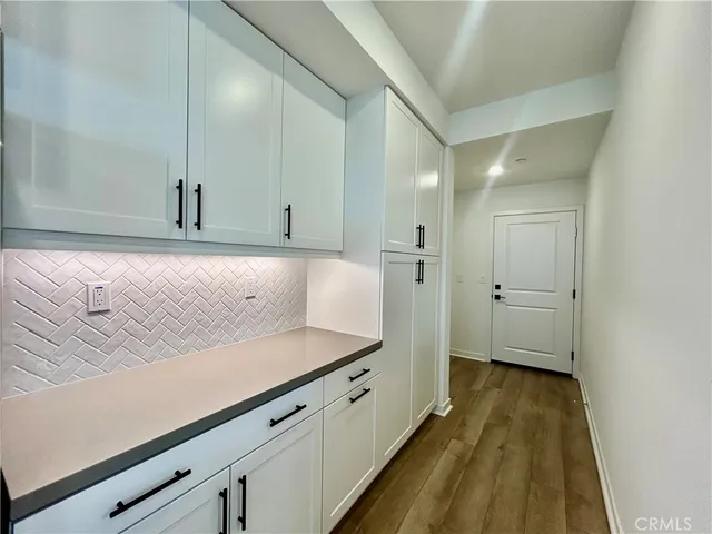 a view of a kitchen cabinets and a wooden floor