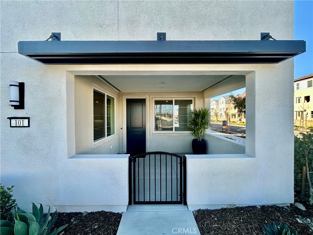 6114 Valentina Way, Unit 101 Eastvale, CA 92880 - Photo 3 of 23 a view of a porch with wooden floor and a potted plant