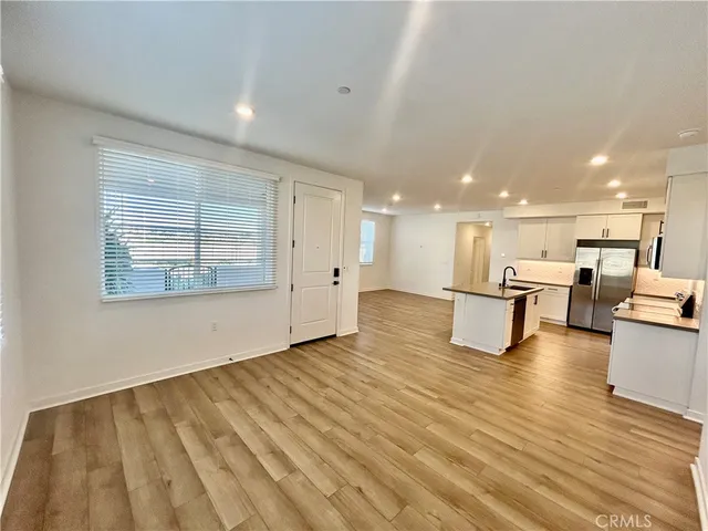 a view of kitchen with furniture and wooden floor