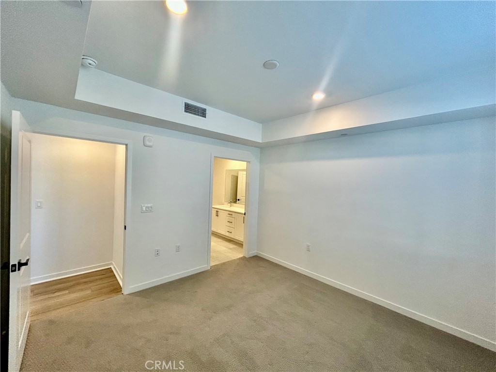 6114 Valentina Way, Unit 101 Eastvale, CA 92880 - Photo 9 of 23 an empty room with windows