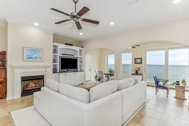 a living room with furniture a fireplace and a flat screen tv