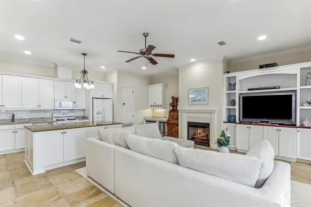 a living room with furniture a floor to ceiling window and a coffee table