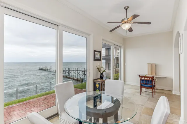 a large kitchen with cabinets wooden floor and a view of living room