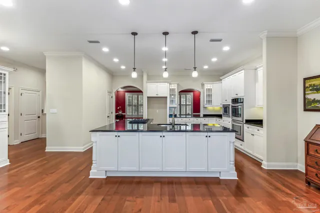 a kitchen with stainless steel appliances kitchen island granite countertop a stove and a refrigerator