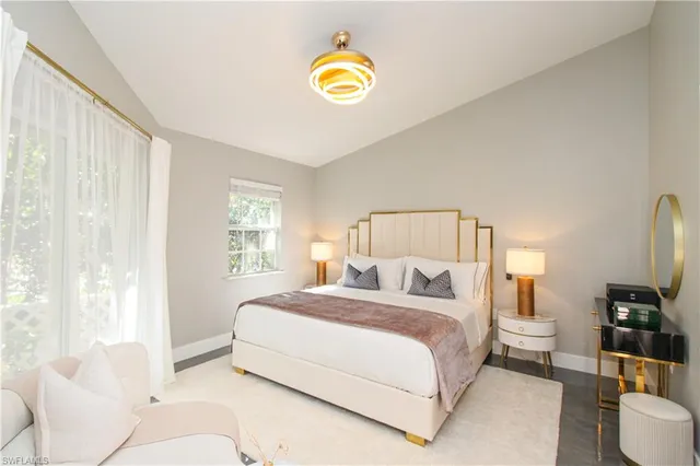 a bedroom with a bed and a lamp