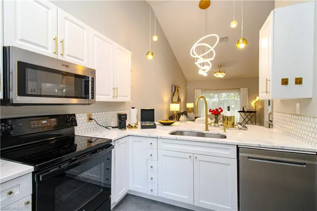 a kitchen with a sink stove and microwave