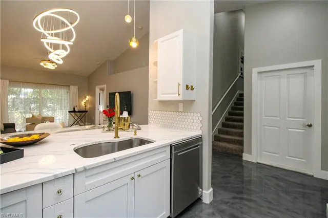 a kitchen with sink and cabinets
