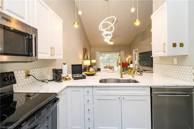 a kitchen with a sink stove and cabinets