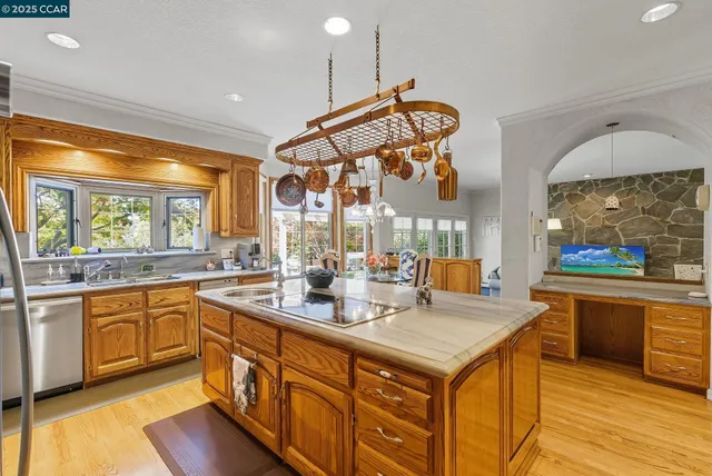 a kitchen with stainless steel appliances granite countertop a stove oven and a refrigerator