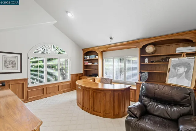 a view of a patio with table and chairs potted plants and floor to ceiling window