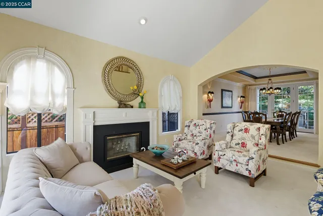 a living room with furniture fireplace and a large window