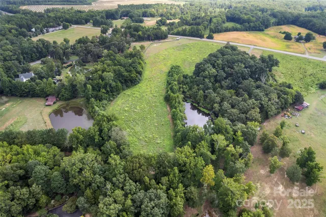 an aerial view of a house with a yard and lake view