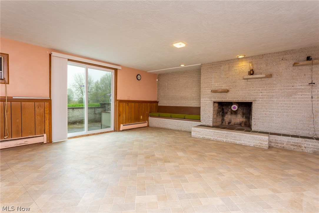 14313 Quarry Road Oberlin, OH 44074 - Photo 18 of 26 Fireplace in Family Room. Seating to the left of the Fireplace covers hiding storage area.