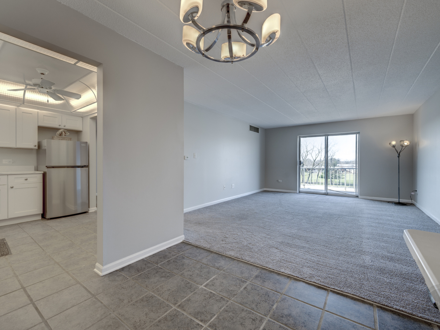 100 West Butterfield Road, Unit 405N Elmhurst, IL 60126 - Photo 10 of 27 an empty room with chandelier fan and windows