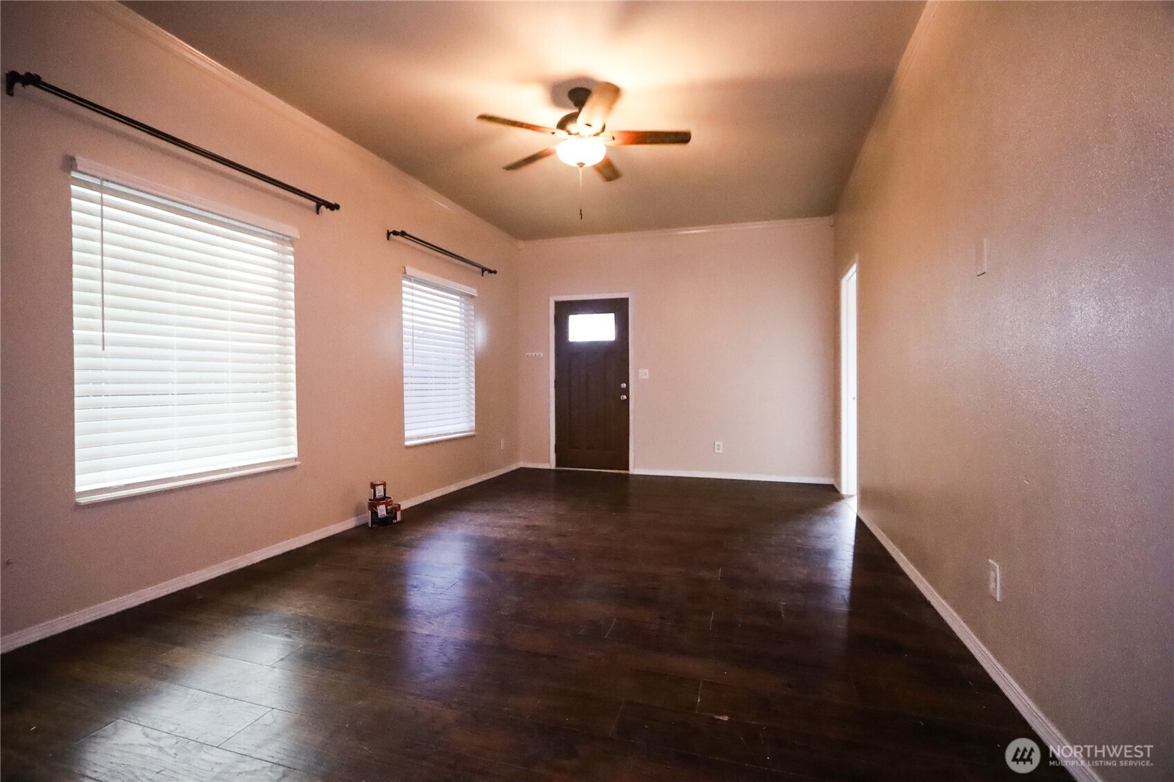 912 Ramer Avenue Hoquiam, WA 98550 - Photo 4 of 20 an empty room with wooden floor and chandelier fan