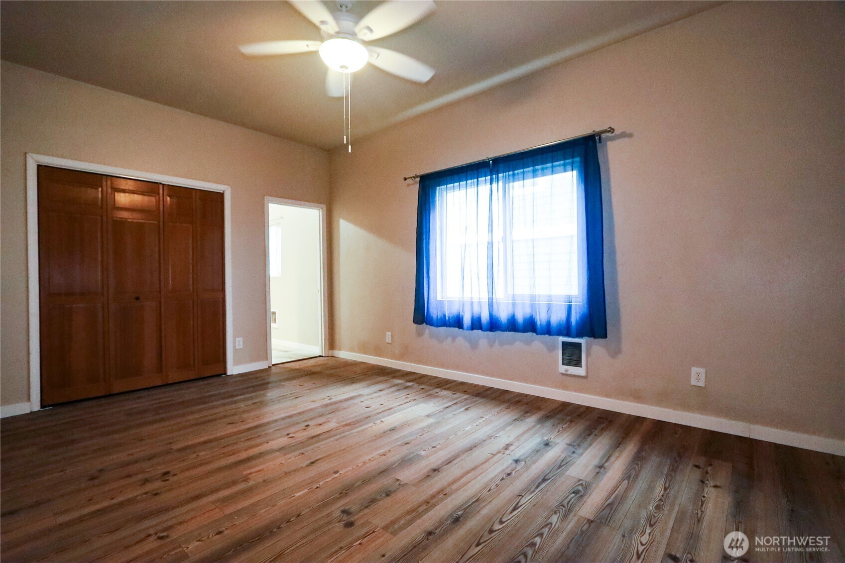 912 Ramer Avenue Hoquiam, WA 98550 - Photo 8 of 20 a view of an empty room with wooden floor and a window