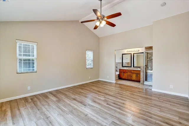 a view of n empty room with window and wooden floor