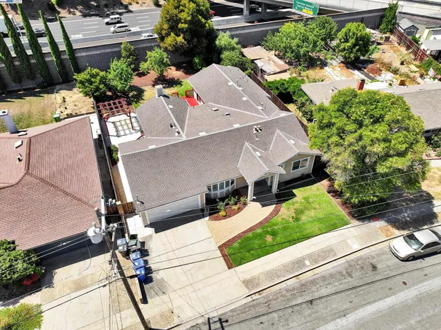an aerial view of a house with a yard