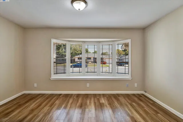 wooden floor in an empty room with a mirror