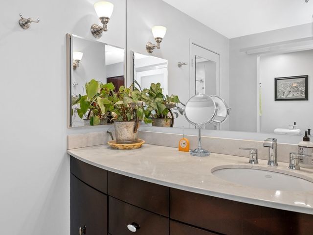 a bathroom with a sink a vanity and a mirror
