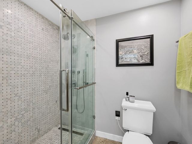 a bathroom with a toilet sink and shower
